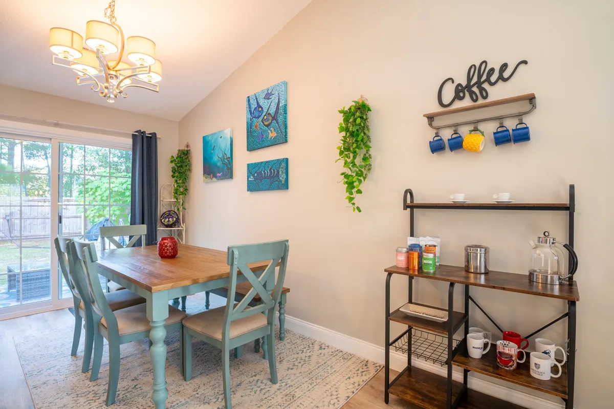A large dining table set against walls adorned with artwork, accompanied by a convenient coffee station. The setup is bright and inviting, ideal for both meals and planning the day’s itinerary.